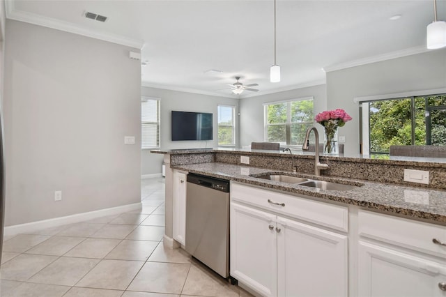 kitchen with dark stone counters, stainless steel dishwasher, a sink, and white cabinets