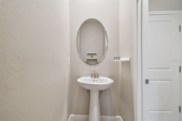 bathroom with a textured wall