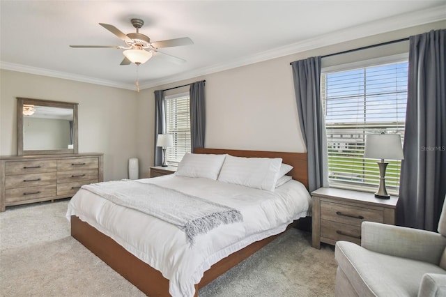 bedroom featuring crown molding, ceiling fan, and light colored carpet