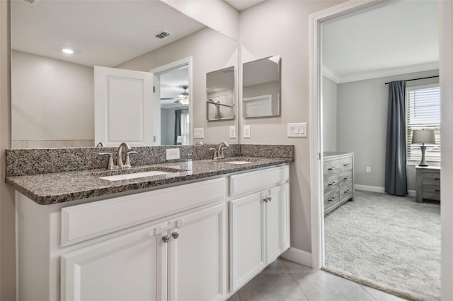 bathroom featuring double vanity, baseboards, visible vents, and a sink