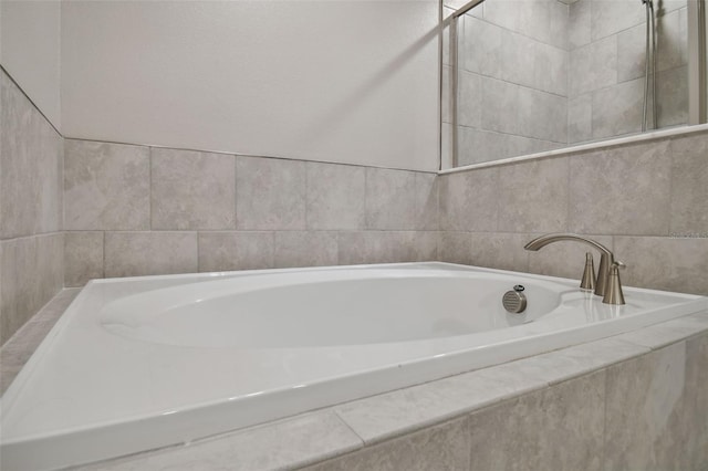 full bathroom featuring a relaxing tiled tub