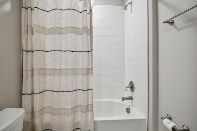 bathroom with shower / bath combo and toilet