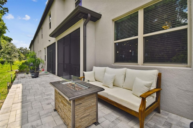 view of patio / terrace featuring an outdoor living space with a fire pit