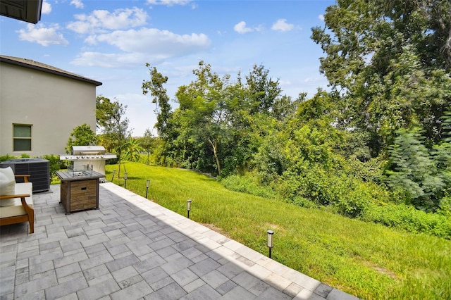 view of patio / terrace featuring cooling unit and a grill