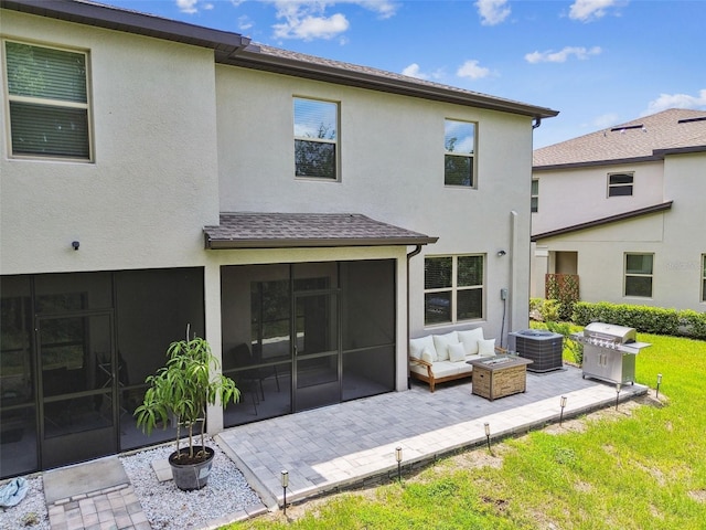 rear view of house with a patio, central AC unit, a sunroom, and stucco siding