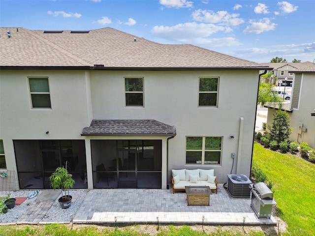 rear view of house with a patio area, a shingled roof, an outdoor hangout area, and a sunroom