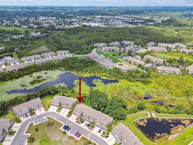 aerial view featuring a residential view, a water view, and a view of trees