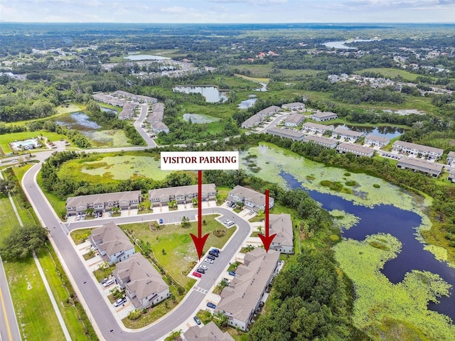 bird's eye view featuring a water view and a residential view