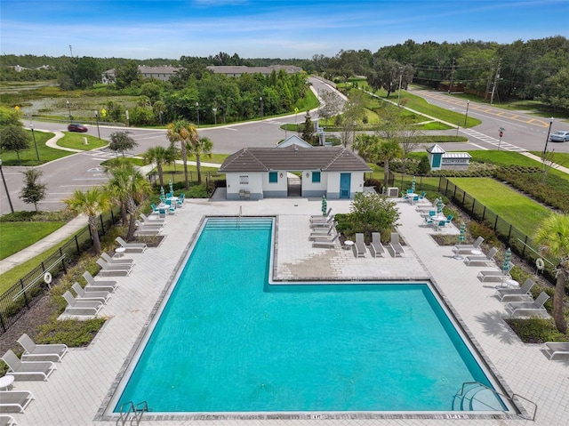 pool with fence and a patio