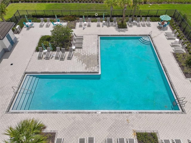 community pool featuring a patio area and fence