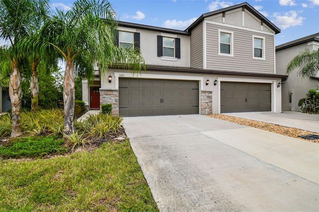 view of front of property featuring a garage, stone siding, concrete driveway, and stucco siding