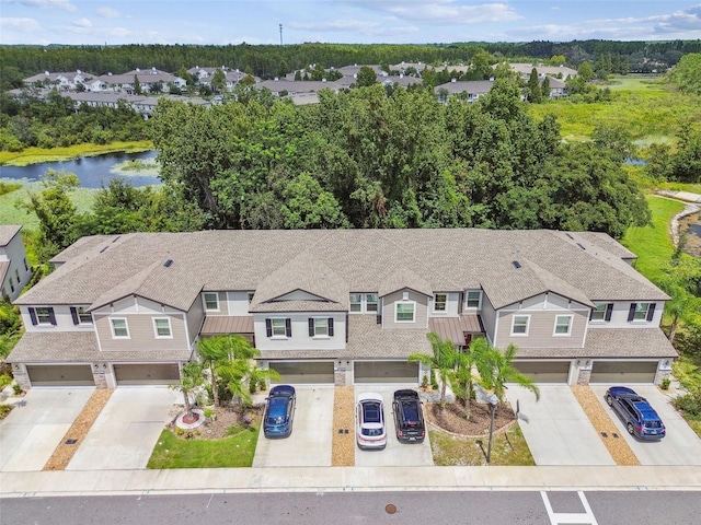 drone / aerial view with a residential view and a water view