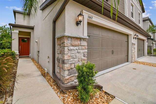 doorway to property with a garage