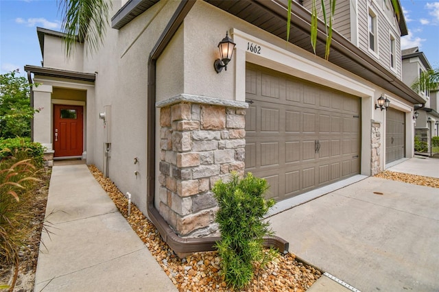 garage featuring concrete driveway