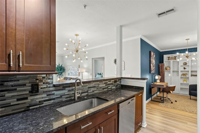 kitchen featuring light hardwood / wood-style flooring, backsplash, dishwasher, sink, and dark stone countertops