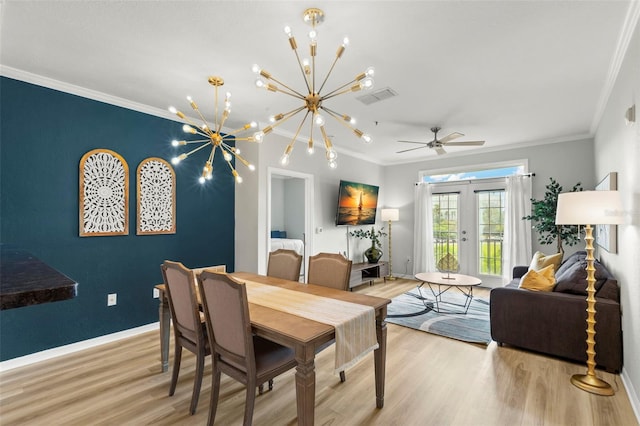 dining area featuring light hardwood / wood-style floors, ceiling fan with notable chandelier, crown molding, and french doors