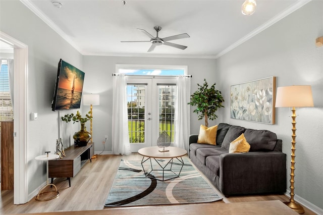 living room with light hardwood / wood-style floors, ornamental molding, french doors, and ceiling fan