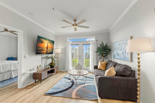 living room featuring light wood-type flooring, french doors, crown molding, and ceiling fan