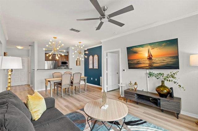 living room with ceiling fan with notable chandelier, crown molding, and light hardwood / wood-style floors