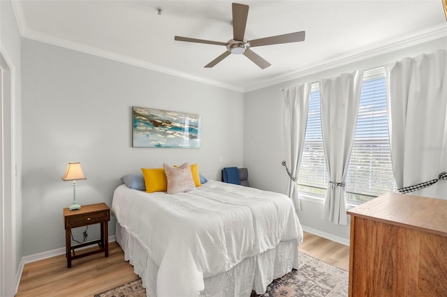 bedroom with ceiling fan, light hardwood / wood-style flooring, and multiple windows