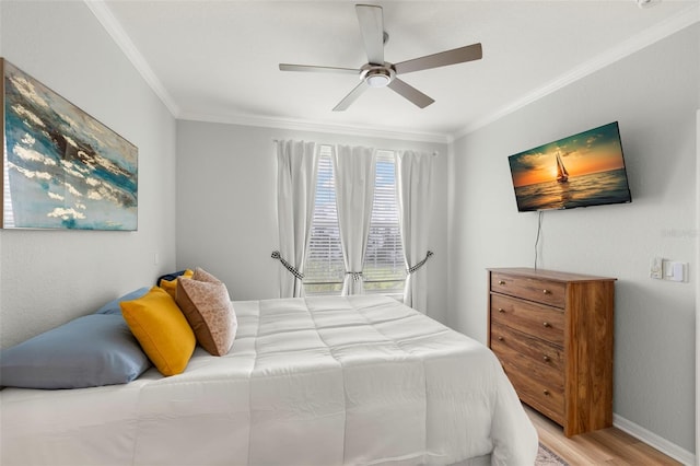 bedroom featuring light hardwood / wood-style flooring, ceiling fan, and crown molding