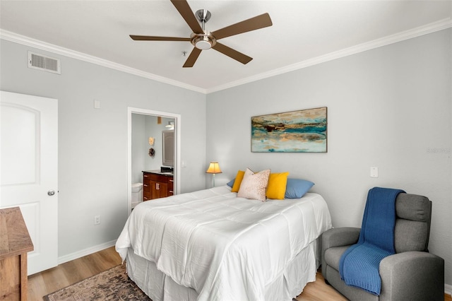 bedroom featuring ceiling fan, light hardwood / wood-style flooring, crown molding, and ensuite bath