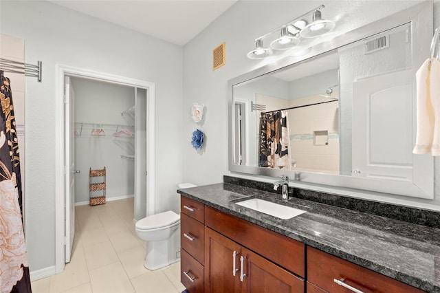 bathroom featuring tile patterned flooring, vanity, a shower with curtain, and toilet