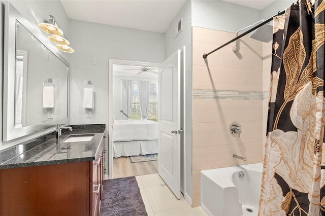 bathroom with ceiling fan, hardwood / wood-style flooring, shower / tub combo with curtain, and vanity