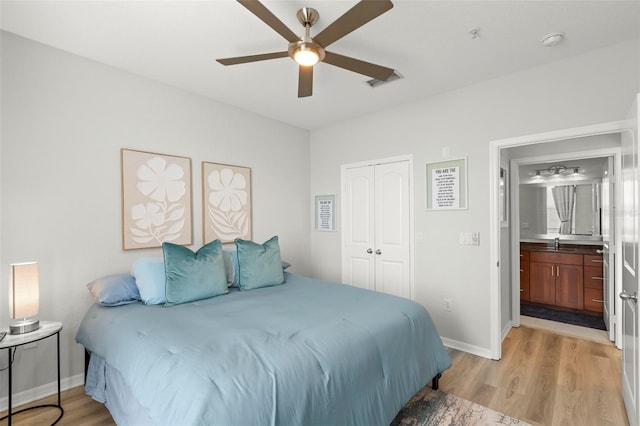 bedroom featuring a closet, ceiling fan, connected bathroom, and light wood-type flooring