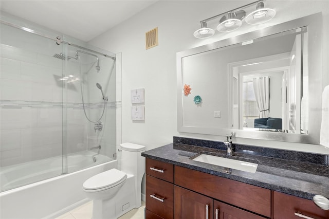 full bathroom featuring combined bath / shower with glass door, tile patterned floors, vanity, and toilet