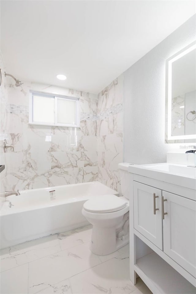 full bathroom featuring tiled shower / bath combo, vanity, and toilet