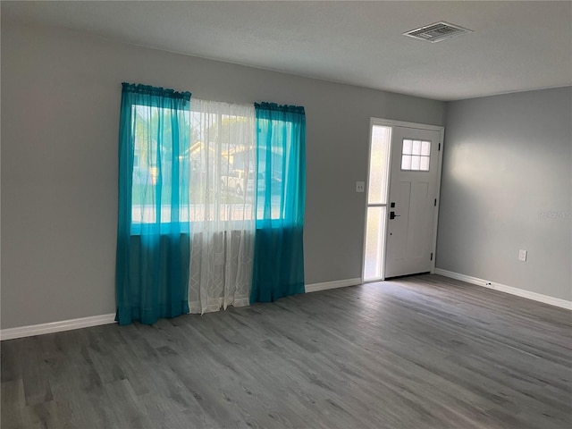 entryway with a textured ceiling and hardwood / wood-style flooring