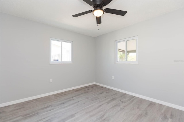 spare room with light wood-type flooring and ceiling fan