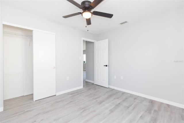 unfurnished bedroom with a closet, ceiling fan, and light hardwood / wood-style floors