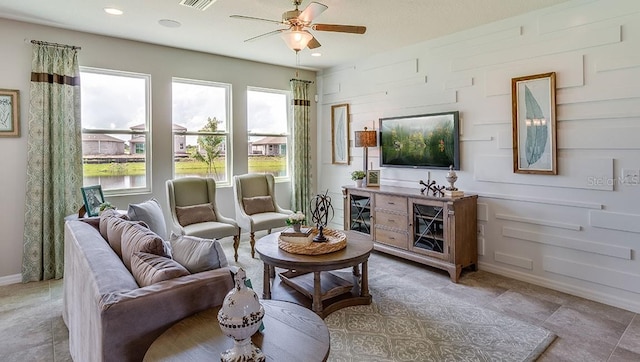 living room featuring ceiling fan, visible vents, and recessed lighting