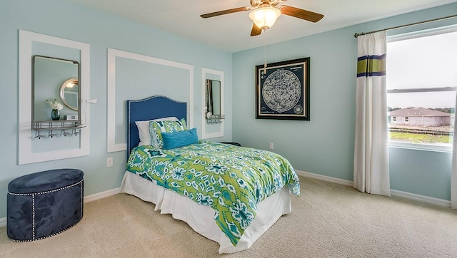 carpeted bedroom featuring ceiling fan and baseboards