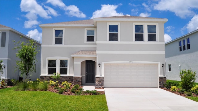 16013 7th Ave E, Bradenton, FL 34212 - view of front facade featuring stone siding, stucco siding, driveway, a garage, and a front lawn