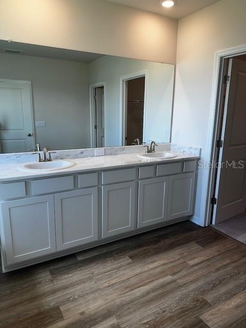 16013 7th Ave E, Bradenton, FL 34212 - bathroom featuring double vanity, wood finished floors, recessed lighting, and a closet