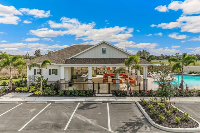 16013 7th Ave E, Bradenton, FL 34212 - view of property featuring a community pool and uncovered parking