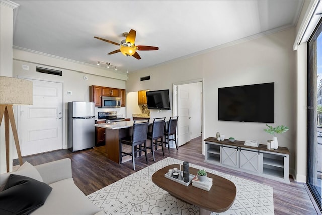 living room featuring ceiling fan, ornamental molding, and dark hardwood / wood-style flooring