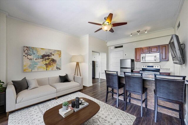 living room with ornamental molding, ceiling fan, dark hardwood / wood-style flooring, and rail lighting