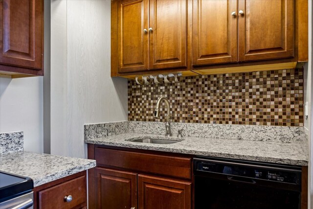 kitchen with sink, backsplash, dishwasher, and light stone countertops