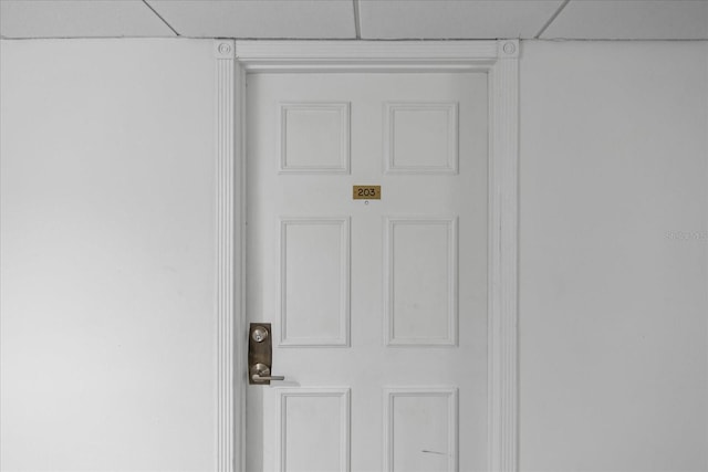 interior details with a paneled ceiling