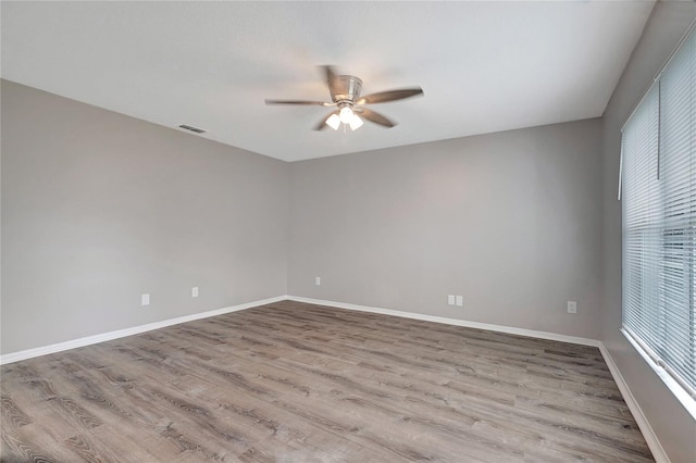 spare room with ceiling fan and hardwood / wood-style flooring