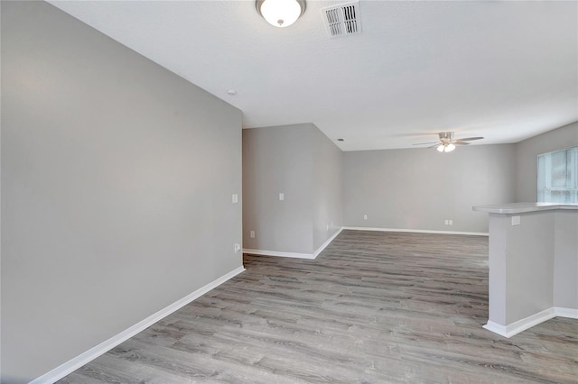 spare room with ceiling fan and light wood-type flooring