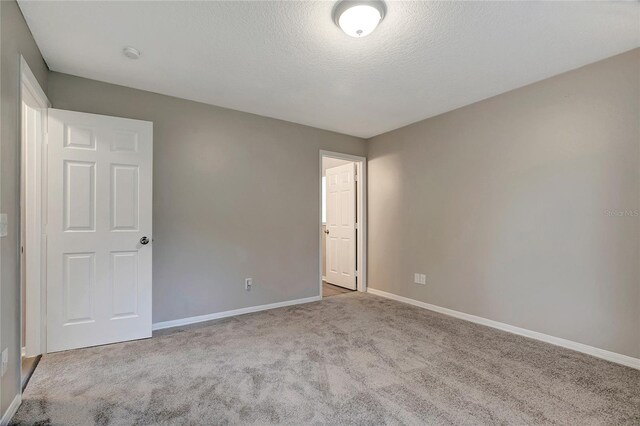 unfurnished bedroom with carpet and a textured ceiling