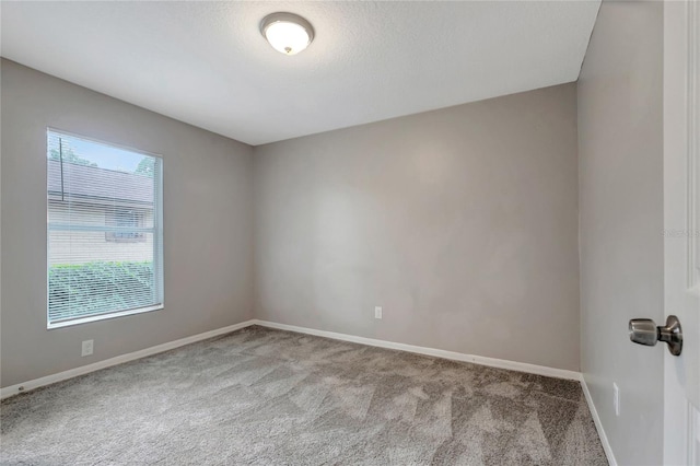 unfurnished room featuring carpet