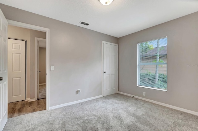 unfurnished room with light colored carpet