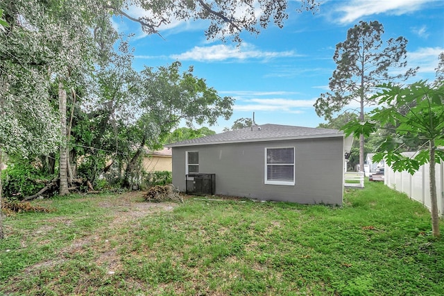 rear view of property with a lawn