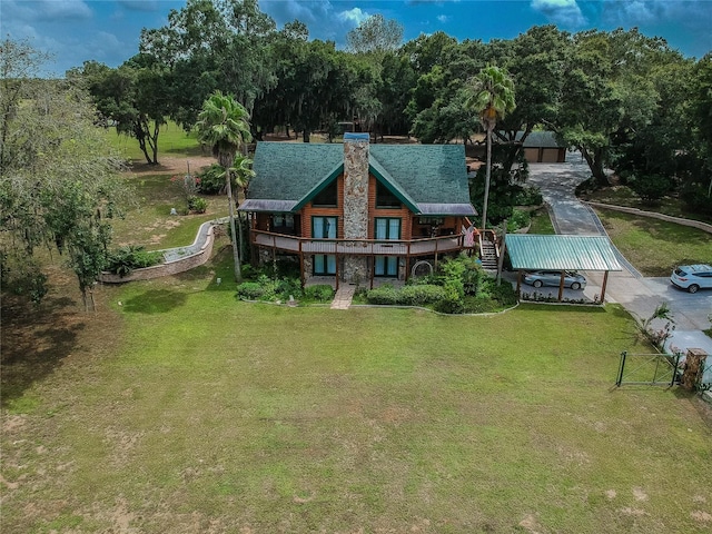 rear view of property featuring a lawn and a chimney